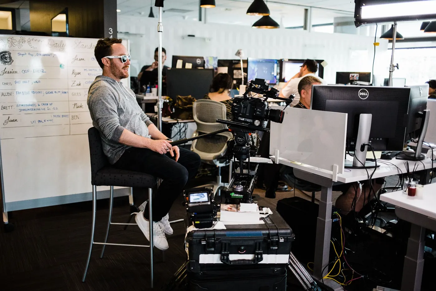 On-set production in a workspace with cinema camera, lights, and crew